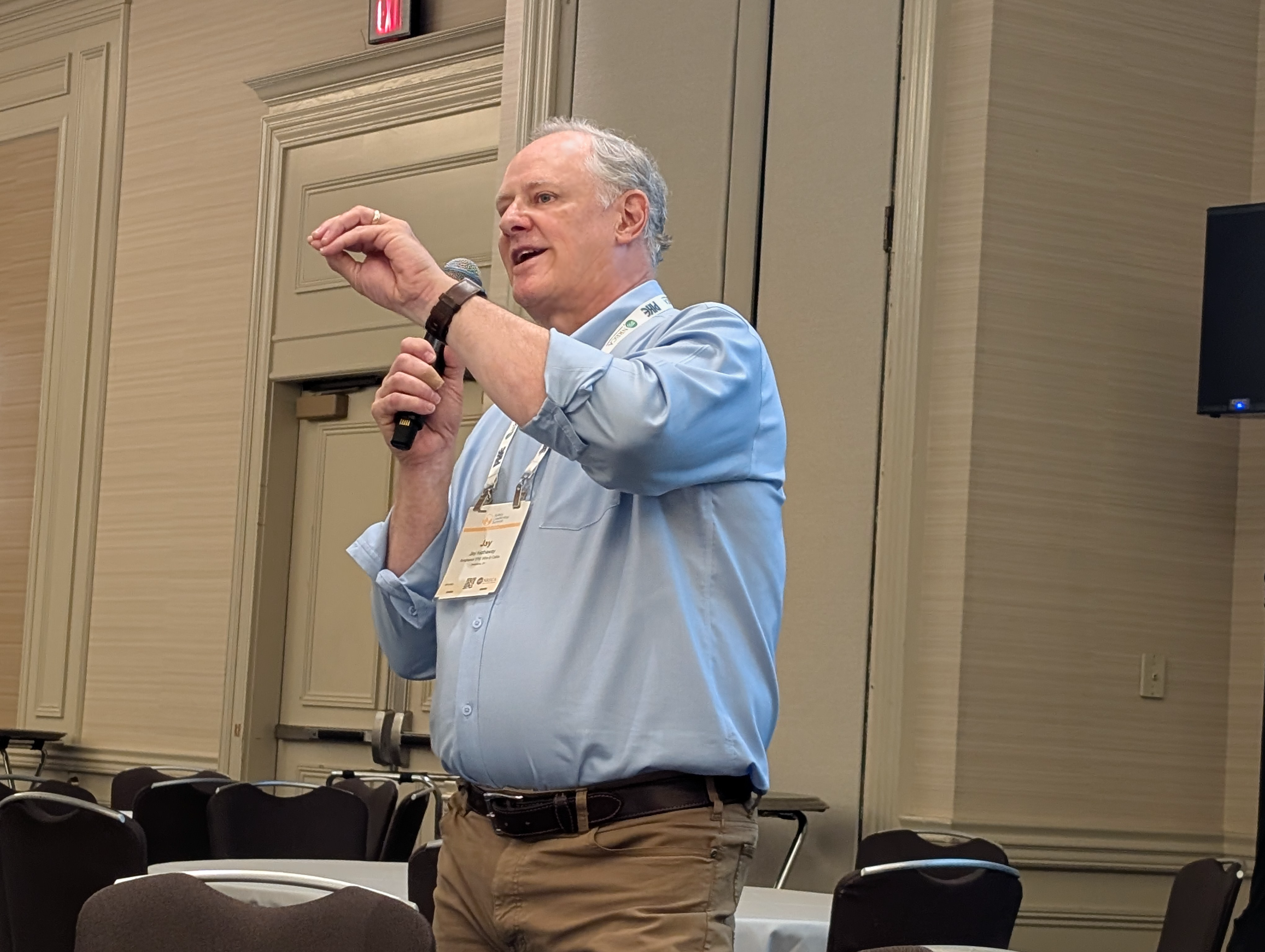 Jay Hathaway, Director – Vertical Market Development at ATPC, presenting with a microphone and one hand raised
